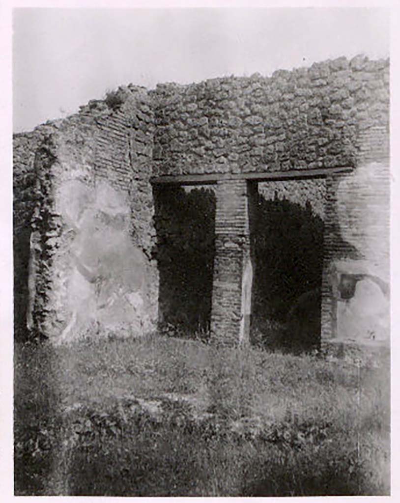 IX.2.26, Pompeii. Pre-1943. Photo by Tatiana Warscher.
According to Warscher –
This photo is of the south-east corner of the atrium.
The two doorways are those to two narrow corridors that lead from the atrium to the pseudo-peristyle.
On the right is the lava base for the money-chest or strong- box (arca).
On the left is the doorway to the room where, according to A. Trendelenburg, on the floor was a mosaic showing two white doves.
(Warscher then wrote “I have not found any trace of this mosaic, and I have not found it at the Museum. I think it has perished.”)
See Warscher, T. Codex Topographicus Pompeianus, IX.2. (1943), Swedish Institute, Rome. (no.133.), p. 239.