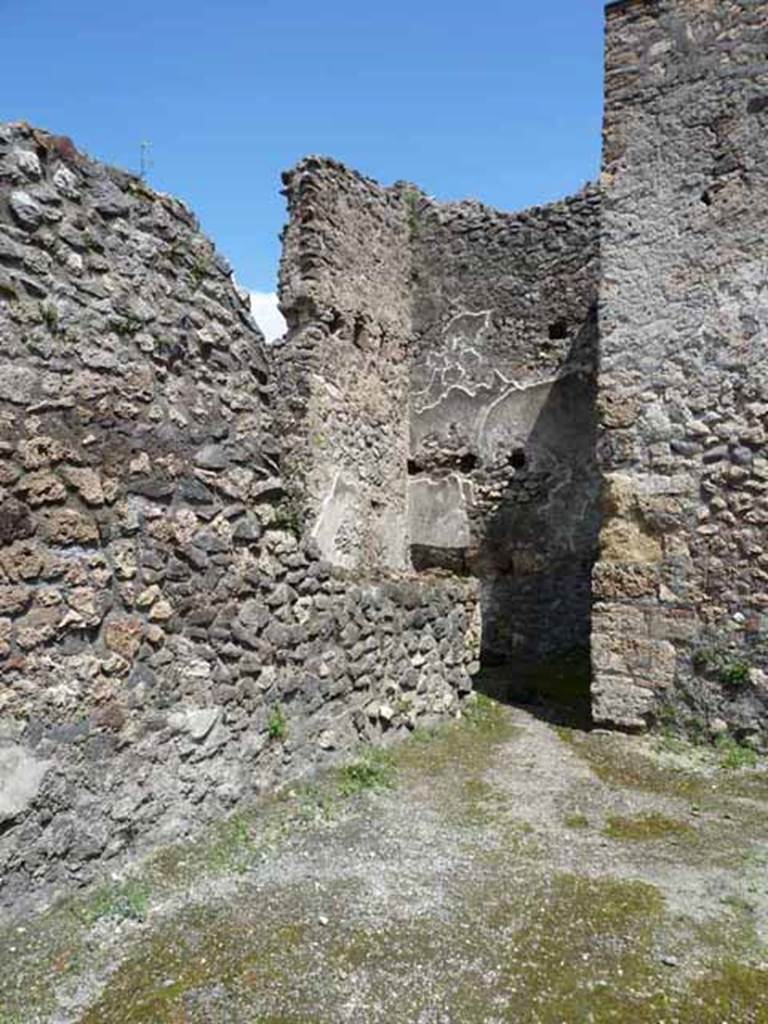 IX.3.4 Pompeii. May 2010. Looking north-east across shop towards small rear room.