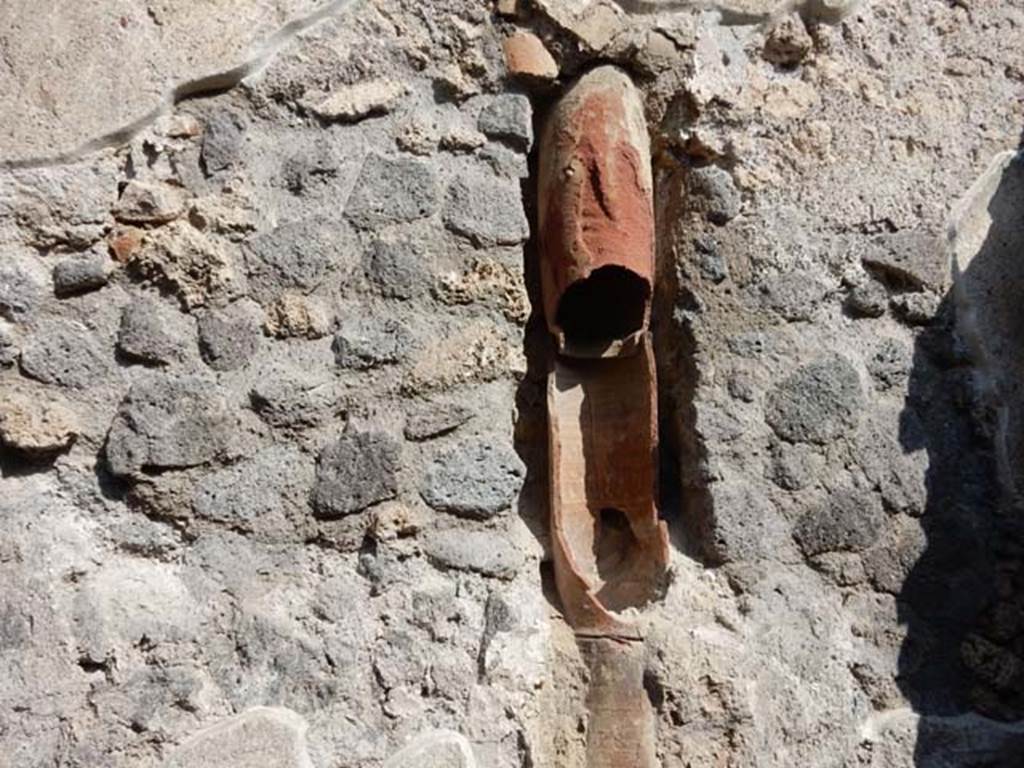 IX.3.5 Pompeii. May 2015. Room 9, detail of terracotta down-pipe in north wall of kitchen. Photo courtesy of Buzz Ferebee.