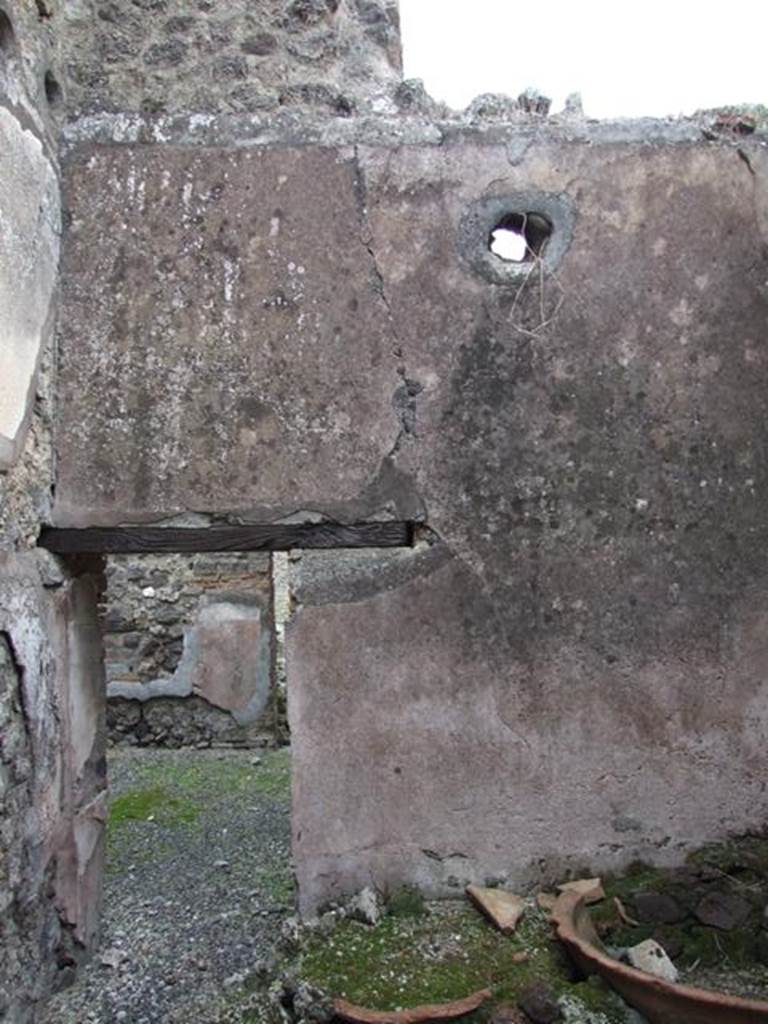 IX.3.20. Bakery. December 2007. Room 4. East wall and doorway with remains of two terracotta basins.