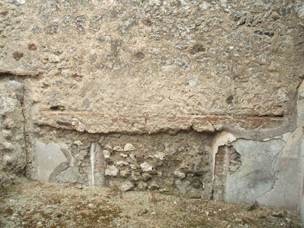 IX.3.23 Pompeii. May 2005. East wall with a blocked doorway, in room in south-east corner of atrium. According to Fiorelli, this would have been a dormitory, with capacity for a few beds. The plinth/zoccolo was red, the middle zone of the wall was white ?. On the half-columns which decorated the doorposts were the remains of painted faux marble.
See also Bragantini, de Vos, Badoni, 1986. Pitture e Pavimenti di Pompei, Parte 3. Rome: ICCD. (p.450)
