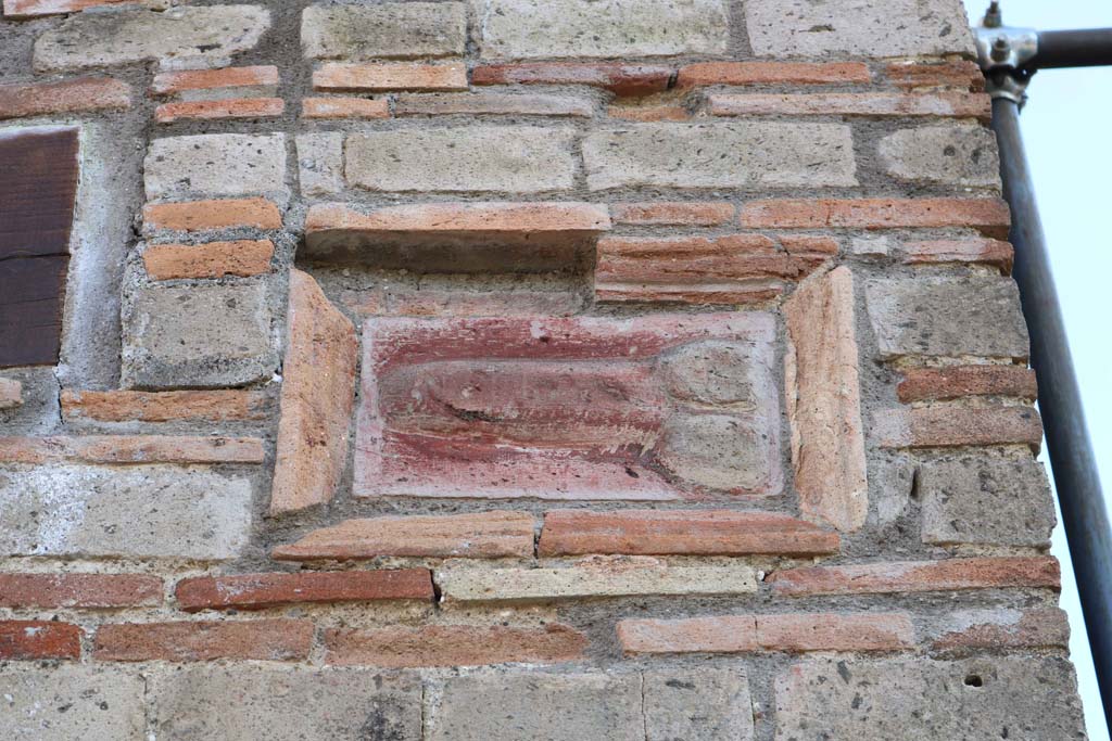 IX.5.1 Pompeii. December 2018.
Terracotta wall plaque of phallus on wall on west side of entrance doorway. Photo courtesy of Aude Durand.