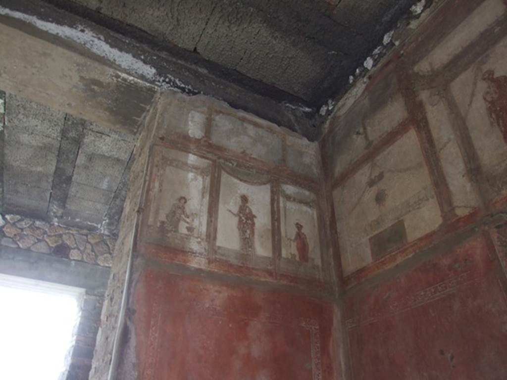 IX.5.6 Pompeii. December 2007. Room 10, upper south-west corner and south wall of tablinum. Wall painting of figures or gods at high level.
