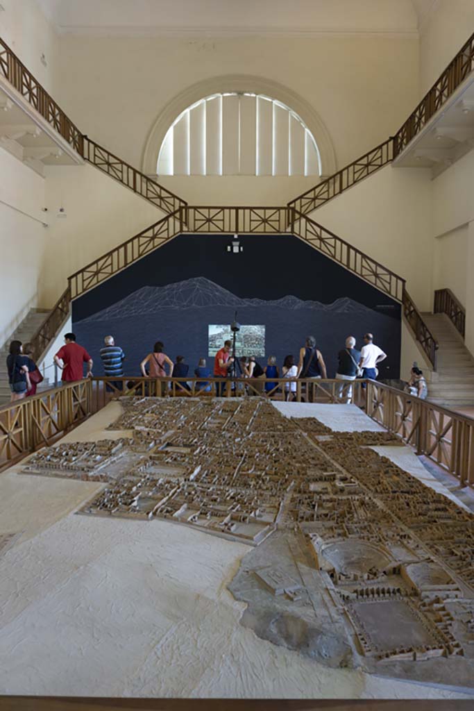 Cork model on display on Naples Archaeological Museum. July 2017.
Looking north from Gladiators Barracks and Theatres at VIII.7 on Via Stabiana, lower right.
Foto Annette Haug, ERC Grant 681269 DÉCOR.
This model in the Naples Archaeological Museum, made of wood, cork and paper, by Felice Padiglione, is scaled at 1/100, and shows the excavations up until the end of 1879.
Many models of the city were produced, including one on display in an exhibition in VIII.2.14/16 in 2018.
That model featured the houses on the western side of VIII.2, that is VIII.2.1/3 the Houses of Championnet, VIII.2.14/16, VIII.2.17/21 the Sarno Baths, and the next few properties on the southern slope.
According to the Archaeological Park of Pompeii display notice in VIII.2.14/16 -
“The cork model was begun in 1865 by Giovanni Padiglione, one of several models predating the great model of the entire city now in Naples Archaeological Museum.
It was created over the course of several stages, following the advance of archaeological discoveries, as demonstrated by the Courtyard of the Moray Eels, excavated at the end of the nineteenth century, and the lower floors of the houses which were investigated in the 1930’s.
In addition, the wall and floor decorations, painted on paper, do not correspond with those that were originally present; most probably it was decided to substitute them with those of a more profound impact from other houses, for educational purposes.”
ses.”