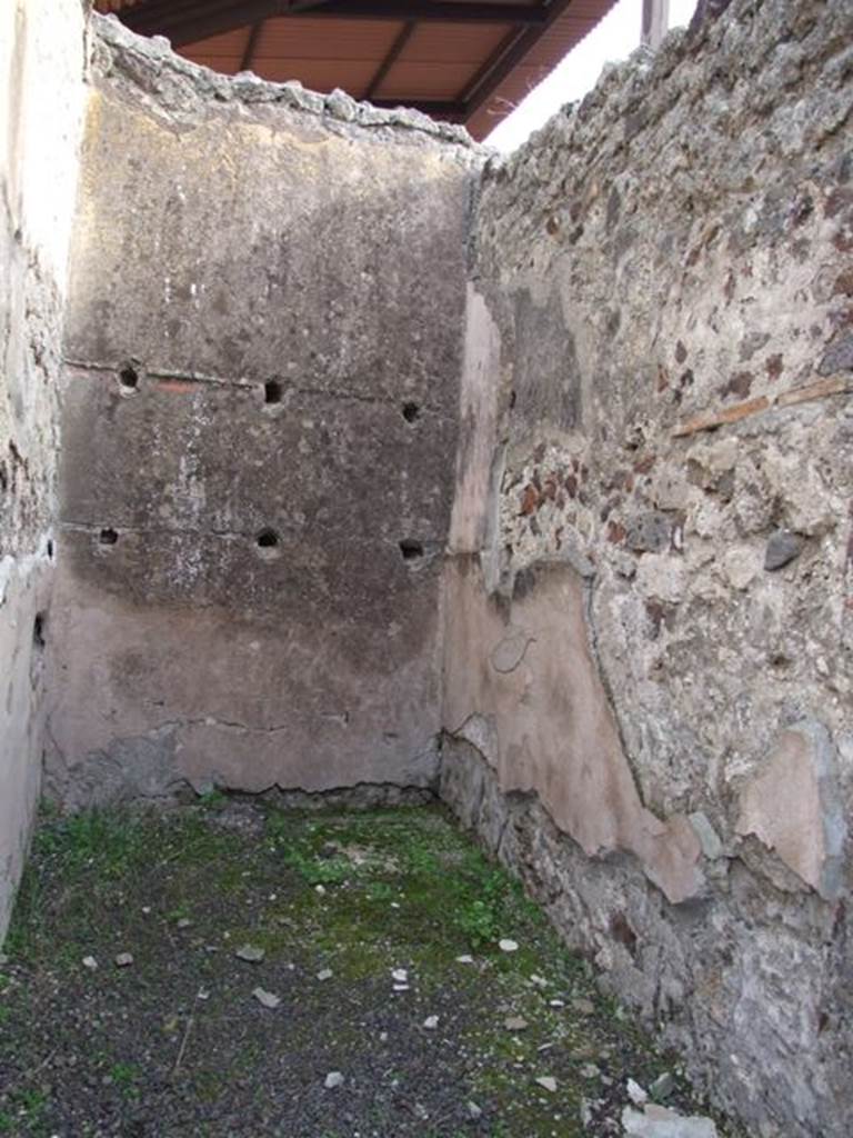 IX.5.9 Pompeii. December 2007. Room 6, small storeroom or cupboard, looking east. On the rear wall are the holes left by the supports for the shelving.