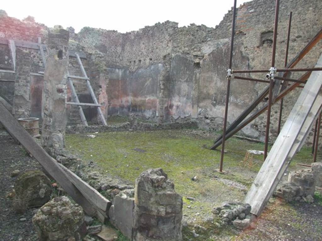 IX.5.9 Pompeii. December 2007. Room 10, looking south-west across peristyle towards room 13. According to Jashemski, this garden had a portico on the east, south and part of the north sides. It was supported by columns covered with yellow stucco, on which were painted garlands of leafy branches amidst which small birds were flying. The columns were connected by a low wall, today badly damaged. There was a large animal painting, only partially preserved upon excavation, on the west wall. See Jashemski, W. F., 1993. The Gardens of Pompeii, Volume II: Appendices. New York: Caratzas. (p.237 & No.94 on p.366)