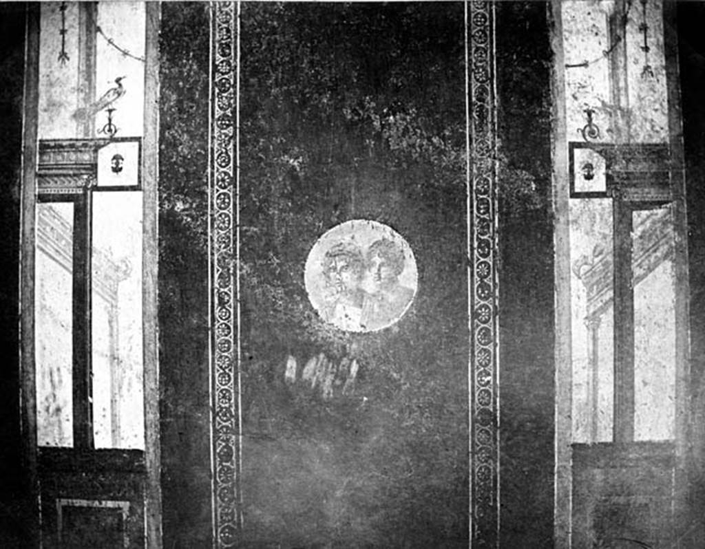 IX.5.11 Pompeii. W.379. Room 8, south wall. Wall decoration from the central panel of the south wall of the ala.
The panel contained a border around a medallion of the head of a male and female.
On either side of the panel were architectural designs, topped by a bird on the left.
Photo by Tatiana Warscher. Photo © Deutsches Archäologisches Institut, Abteilung Rom, Arkiv.
See http://arachne.uni-koeln.de/item/marbilderbestand/230996