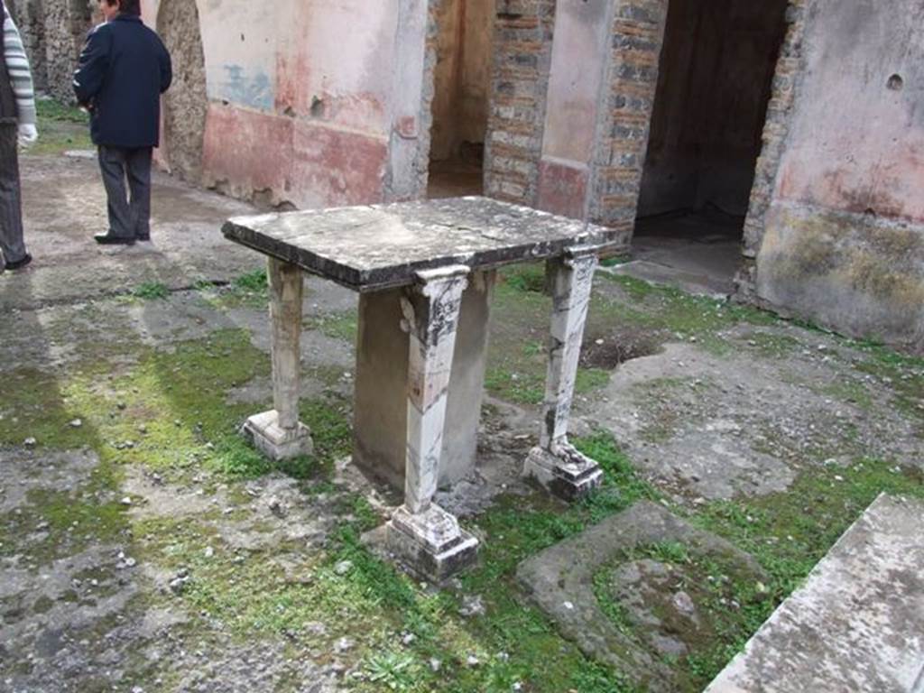 IX.5.11 Pompeii. December 2007. Room 1. Atrium. Cartibulum or marble table. Looking southwest across to west side of atrium and door ways to rooms 6 and 7.