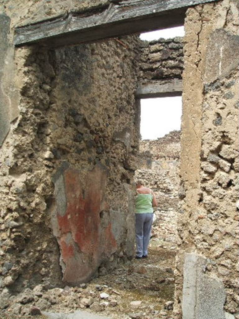 IX.5.18 Pompeii. May 2005. Room a, entrance with west wall of fauces. In the left wall of the entrance corridor, the remains of decorations were seen in two red panels. In the second red panel, a graffito of a sailing ship was seen.
See Notizie degli Scavi, 1878, (p.263)
