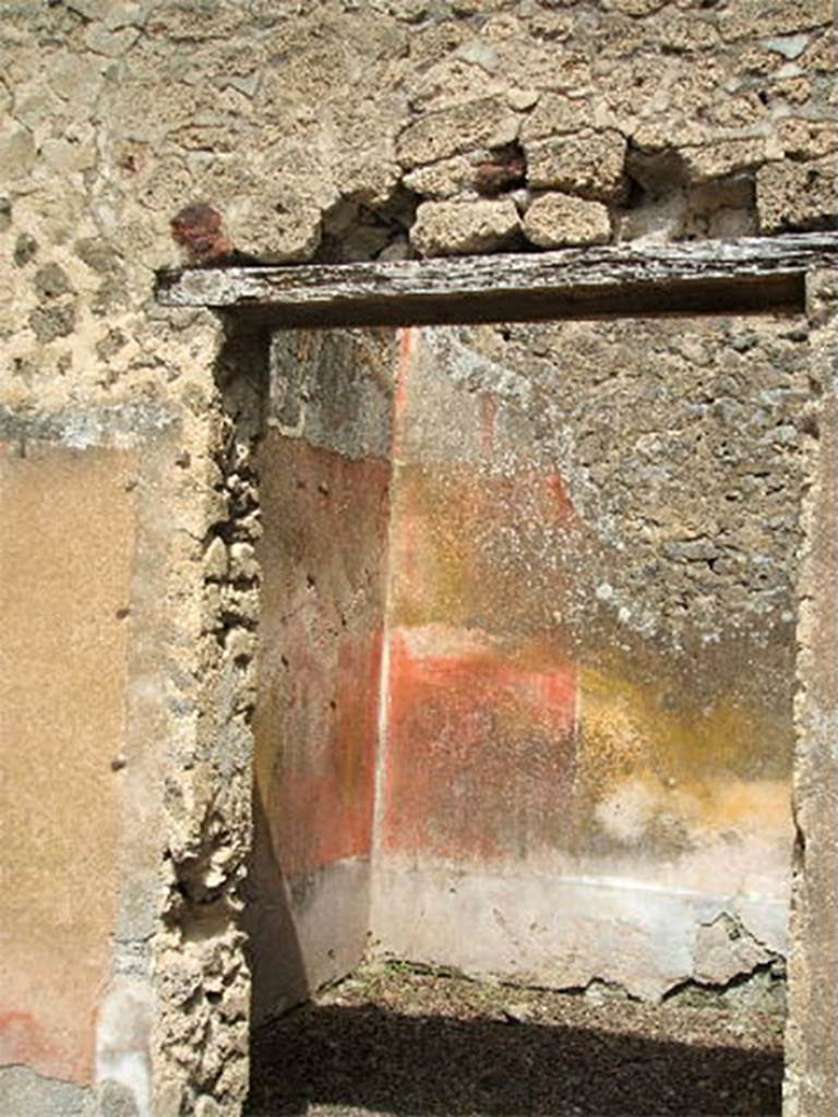 IX.6.5 Pompeii. May 2005. Doorway to room “d”, originally the north ala.
According to Mau, this room had a simple decoration on its walls in a style that was difficult to attribute to the III or IV style of decorative painting. 
See Mau in BdI, 1880,  (p.227-8)
A statuette of white marble Pigmy was found in room “d”, on 24/10/1878. 
Now in Naples Archaeological Museum.  Inventory number 120406.
See Marmora Pompeiana nel Museo Archeologico Nazionale di Napoli: Studi della SAP 26, p. 178.
