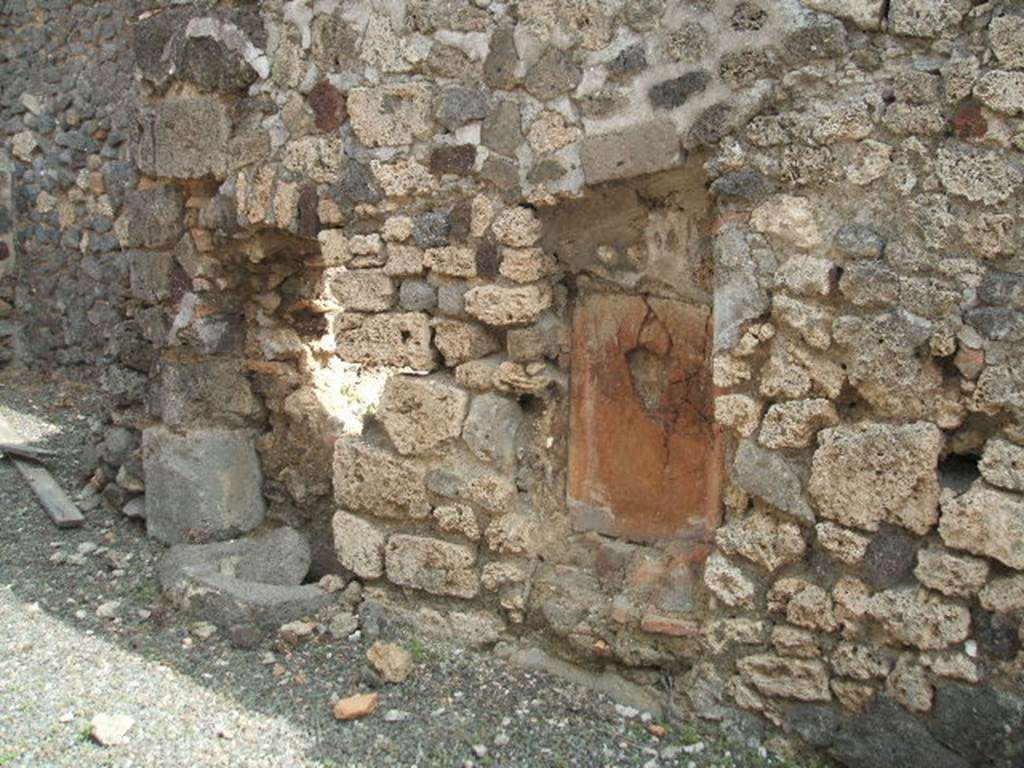 IX.6.b Pompeii. May 2005. East wall of middle room at rear of bar, described by Mau as the kitchen. On the right (east) side of the kitchen, according to Mau, was firstly the hearth followed by the cistern made from of lavastone without a puteal. On the left side, firstly was the latrine (in a vaulted niche) and a water-pipe from the upper floor, followed by the first step of the stairs that led up the left wall of the last room, leading up to the upper floor.
See also Mau in BdI 1881, (p.30-1)