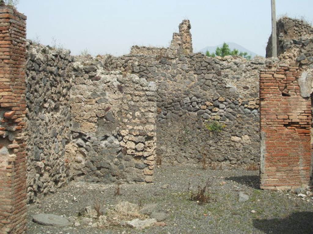 IX.6.c Pompeii. May 2005. Entrance doorway, looking north. According to Mau, this was described as a shop with a rear-room. On the right wall of the shop, the stairs would have been leaning that led to one or two upper rooms. The walls were simply painted; on the right wall of the rear-room one could see traces of a kind of representation made with red colour on a white background.
Mau in BdI, 1881, p.30 (described as no.12).