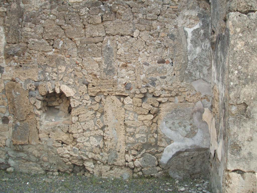IX.6.e Pompeii. May 2005. Niche on east wall.
According to Boyce, in the east wall of the taberna was a niche with peaked ceiling.
Its walls were coated with white stucco outlined in red.
Around it on the wall was a lararium painting, of which only a cornucopia on the left side could be seen when excavated.
See Boyce G. K., 1937. Corpus of the Lararia of Pompeii. Rome: MAAR 14. (p.87, no.433)
According to Sogliano, in the shop a sacred picture was found.
See Notizie degli Scavi di Antichità, 1879, p. 72.
See Sogliano, A., 1879. Le pitture murali campane scoverte negli anni 1867-79. Napoli: (p. 19, no. 71).