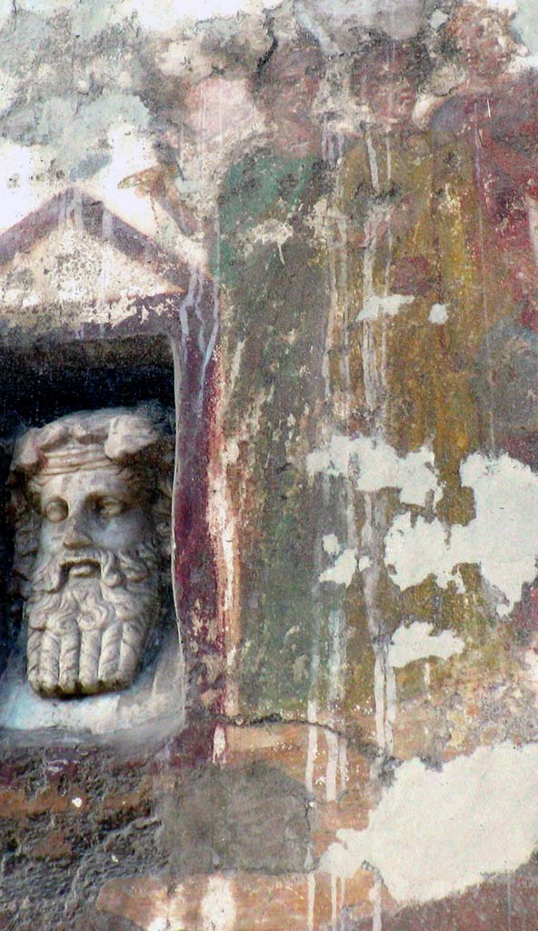 IX.7.1 Pompeii. March 2008. Fresco with a little marble bust of Dionysus.
Marble bust of Dionysus in niche, on left, fresco showing the procession in honour of the goddess Cybele, on right.
Photo courtesy of Davide Peluso.