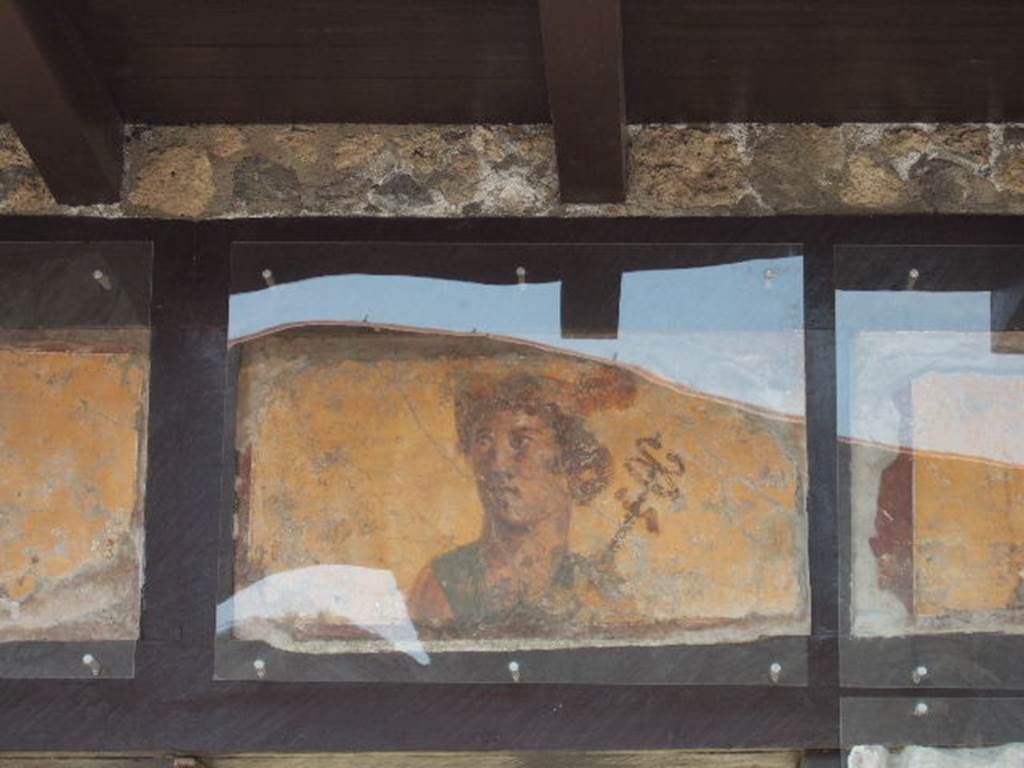 IX.7.1 Pompeii. May 2006. Painting of Mercury with a red Petasos and the Caduceus on his left shoulder. See Fröhlich, T., 1991, Lararien und Fassadenbilder in den Vesuvstädten. Mainz: von Zabern. (F63: p.332).