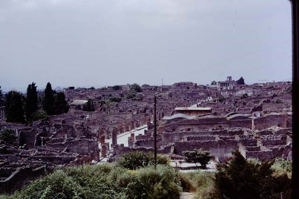 View looking west along the Via dell’Abbondanza, taken from above IX.7.12, Pompeii, 1973. Photo by Stanley A. Jashemski.
Source: The Wilhelmina and Stanley A. Jashemski archive in the University of Maryland Library, Special Collections (See collection page) and made available under the Creative Commons Attribution-Non Commercial License v.4. See Licence and use details. J73f0233