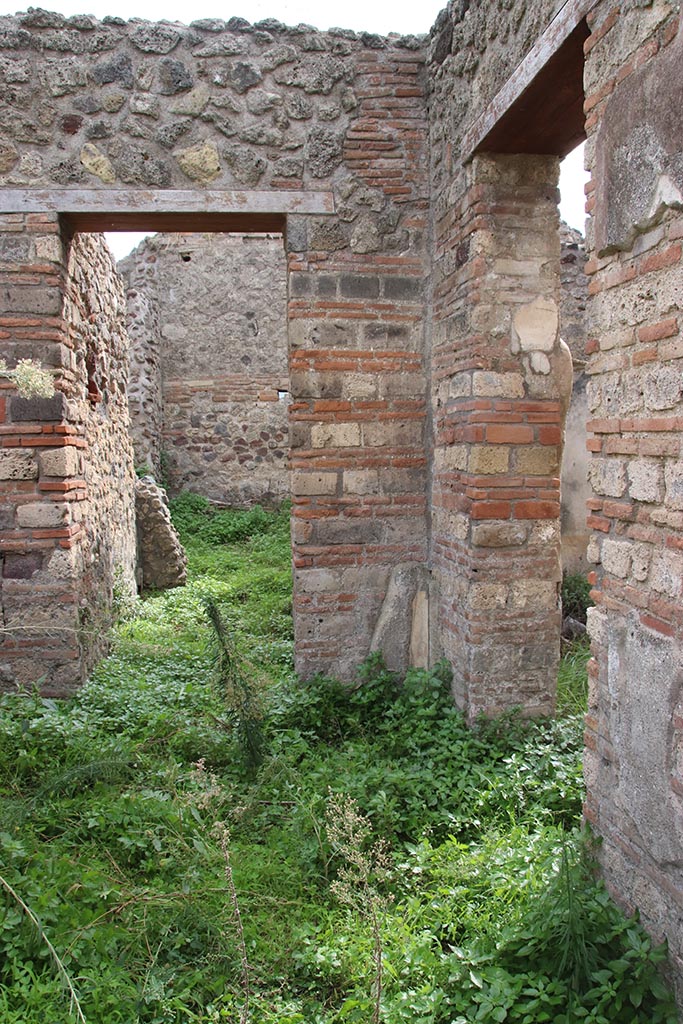 IX.7.16 Pompeii. October 2024.
Looking towards south-west corner of atrium 2, with doorway to room 3, on left, and into room “b”, on right. Photo courtesy of Klaus Heese.