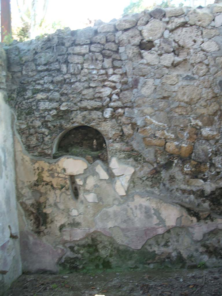 IX.7.20 Pompeii. May 2005. Niche in kitchen, room (p).
According to Boyce, in the west wall of the kitchen, in the south-west corner of the house, was once a niche.
This niche was coated with white stucco but was subsequently bricked-up.
See Boyce G. K., 1937. Corpus of the Lararia of Pompeii. Rome: MAAR 14. (p.88, no.440)
See Giacobello, F., 2008. Larari Pompeiani: Iconografia e culto dei Lari in ambito domestico. Milano: LED Edizioni. (p.210, no.107)