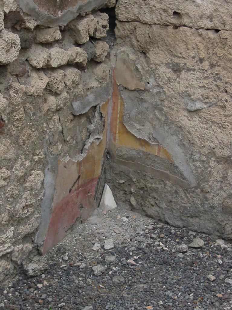 IX.7.22 Pompeii. May 2003.
Remains of painted plaster in the room on east side of caupona. Photo courtesy of Nicolas Monteix.