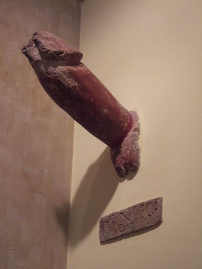 IX.8.6 Pompeii. Phallus. Now in Naples Archaeological Museum. Inventory number 113415.
According to BdI, fixed into the external side of the east wall of the house was a very large tufa phallus, painted in red with the inscription
HANC . EGO
CACAVI
See Bulletino dell’Instituto di corrispondenza archaeologica, 1882, p.115