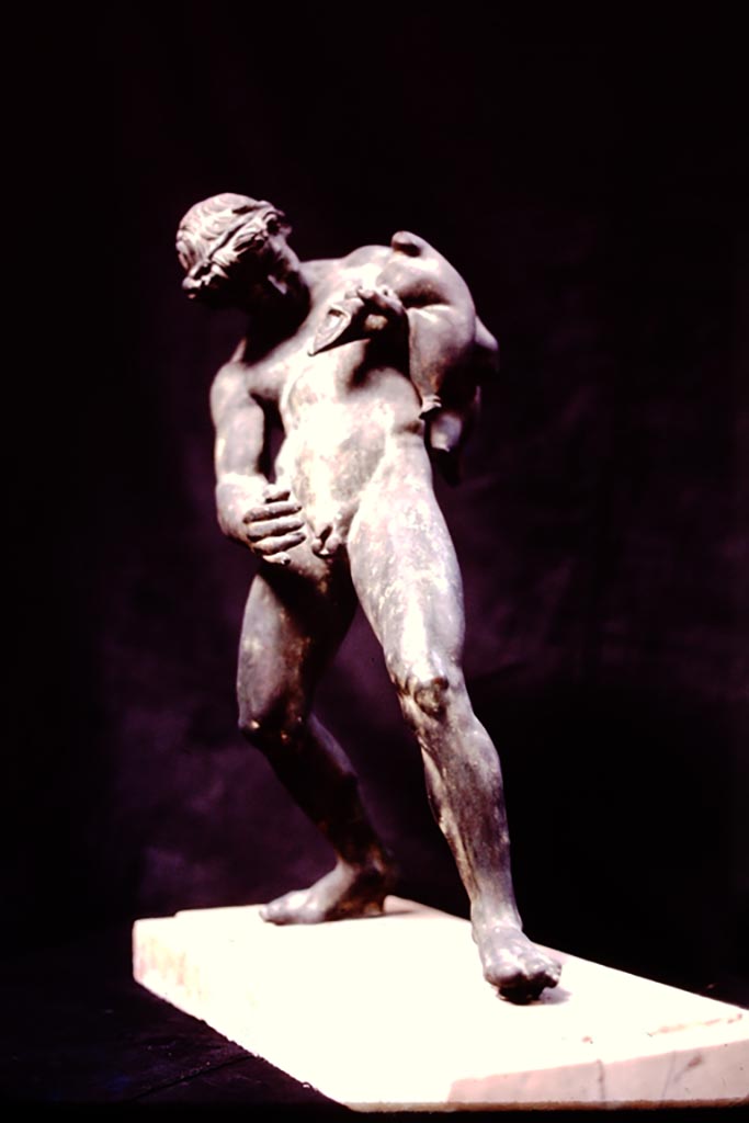 IX.8.6 Pompeii, 1982 or 1983.
Bronze statue of satyr (0.51m high) found standing on a small tufa base in the middle of the rounded part of the north edge of the pool, facing south.
Now in Naples Archaeological Museum. Inventory number 111495. (Ruesch no. 815).
Source: The Wilhelmina and Stanley A. Jashemski archive in the University of Maryland Library, Special Collections (See collection page) and made available under the Creative Commons Attribution-Non-Commercial License v.4. See Licence and use details.
J80f0510