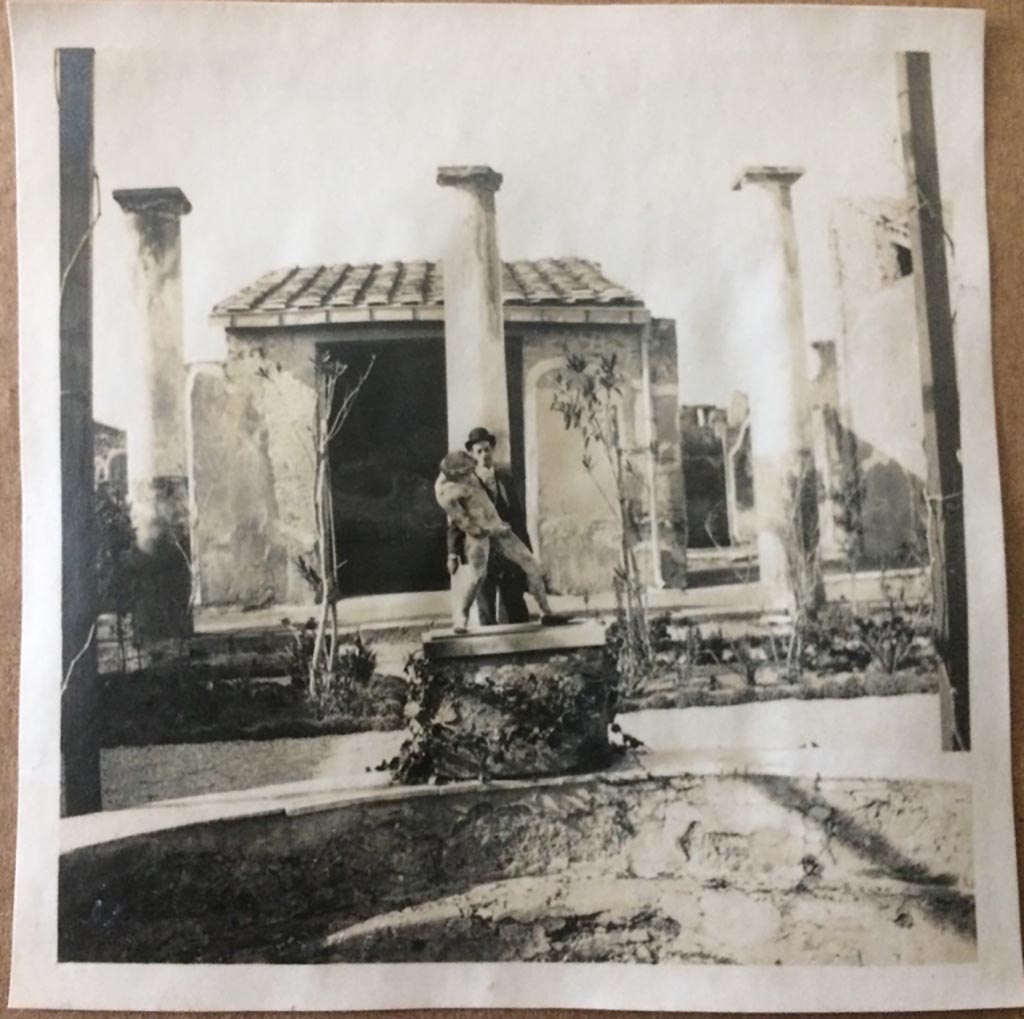 IX.8.6 Pompeii. August 27, 1904. Looking north across pool in peristyle, towards copy of statue of satyr with wineskin.
Photo courtesy of Rick Bauer.
