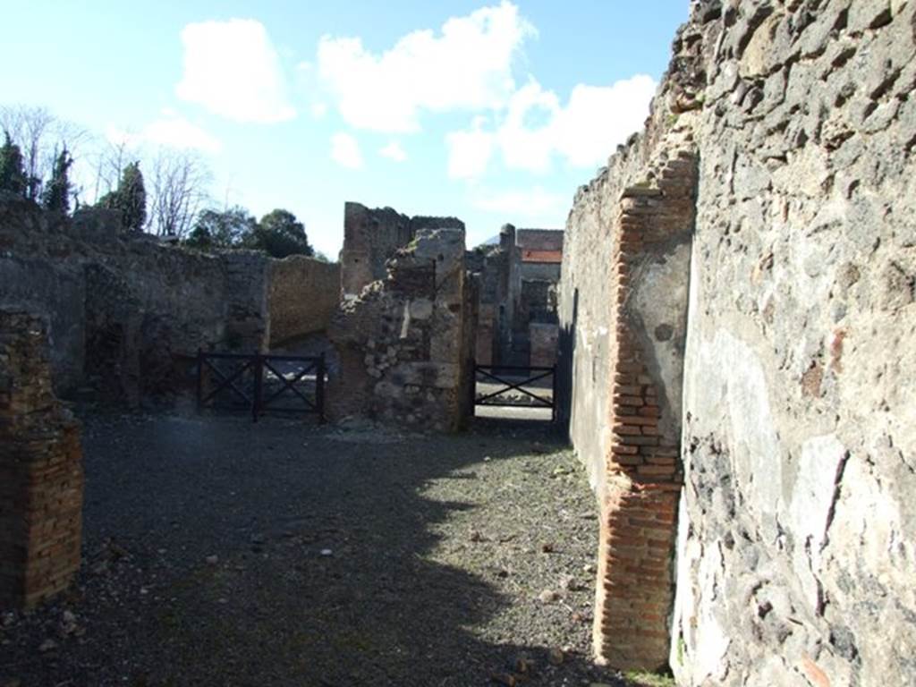 IX.9.2 Pompeii. March 2009. Looking north from rear, towards thermopolium at IX.9.1 (on left) and entrance passageway (on right). According to NdS, this would be looking north across the atrium displuviate (atrium without an impluvium). The flooring was made of crushed brick (mattone pesto) and the walls were covered with rustic plaster. Near the west wall was the staircase to the upper floor, made of 13 masonry steps, which was held up by pilasters and arches. Underneath the stairs, these formed three plastered storage recesses or cupboards of different heights. According to NdS, the steps would have been clad with wood on the upper side. In the north-west corner there was a fusorium, or sink.
See Notizie degli Scavi, 1888, p.514-5