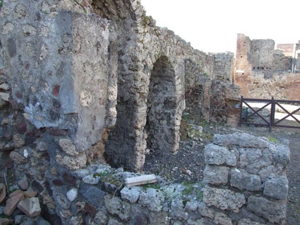 IX.9.2 Pompeii. March 2009. Looking north from cubiculum “d” through window into atrium with stairs to upper floor, and 3 arched recesses underneath.