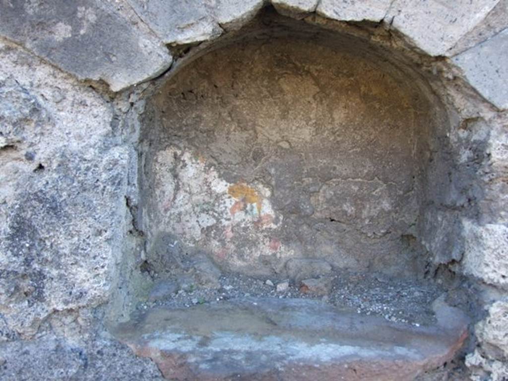 IX.9.a/2 Pompeii. March 2009. Remains of painting are visible in the Niche.
In the floor of the niche is a hole for the base of a statue. See Giacobello, F., 2008. Larari Pompeiani: Iconografia e culto dei Lari in ambito domestico. Milano: LED Edizioni. (IX.9.2:110, p.213). See Boyce G. K., 1937. Corpus of the Lararia of Pompeii. Rome: MAAR 14. (IX.9.2: 454)