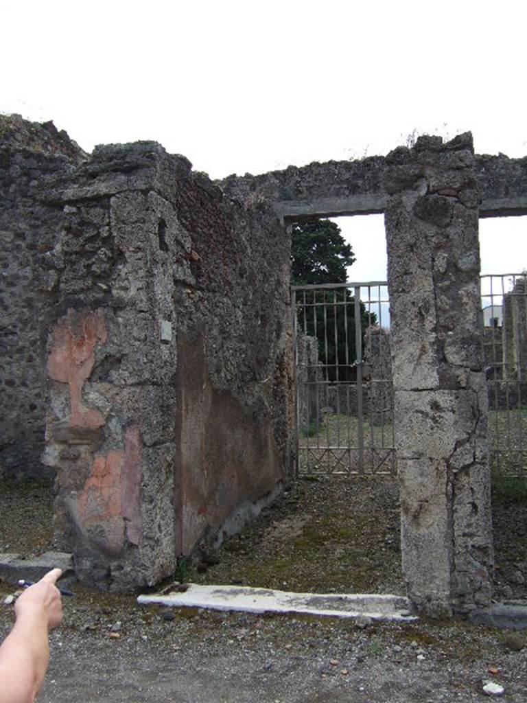 IX.9.4 Pompeii. May 2006. Entrance, looking south along east wall of vestibule and fauces.
This entrance doorway was described as having a travertine threshold. The flooring was of opus signinum and sloped down towards the Via di Nola. The walls of the entrance corridor were painted red. See Notizie degli Scavi, 1888, p.515.
