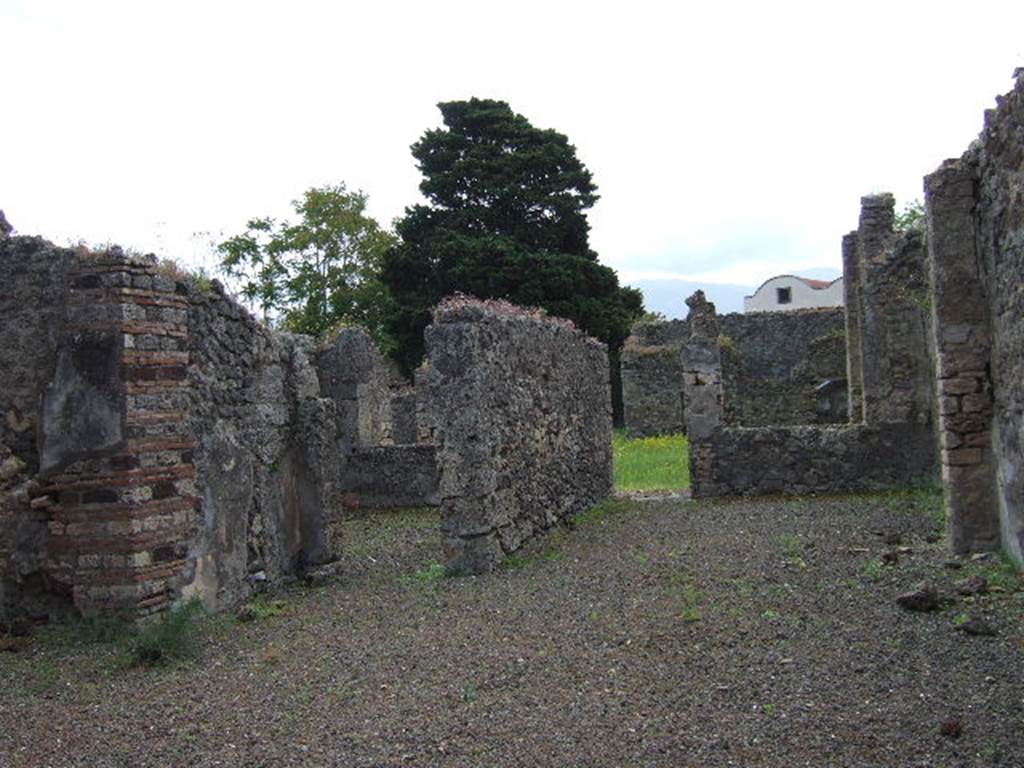 IX.9.4 Pompeii. May 2006.
Looking south across atrium, with doorway to room ‘g’, triclinium, left of centre, and doorway from room ‘f’, tablinum to garden.
According to Boyce –
In the north wall of the portico which looks out onto the garden from the north side, is a vaulted niche (h.0.40, w.0.40, d.0.12, h. above floor 1.60) – probably the lararium, according to Mau. On the ground before it lies a cube of travertine (0.24) which may have served as altar.
See Boyce G. K., 1937. Corpus of the Lararia of Pompeii. Rome: MAAR 14. (p.91, no.455).
See Giacobello, F., 2008. Larari Pompeiani: Iconografia e culto dei Lari in ambito domestico. Milano: LED Edizioni, (p.286 no.V82)