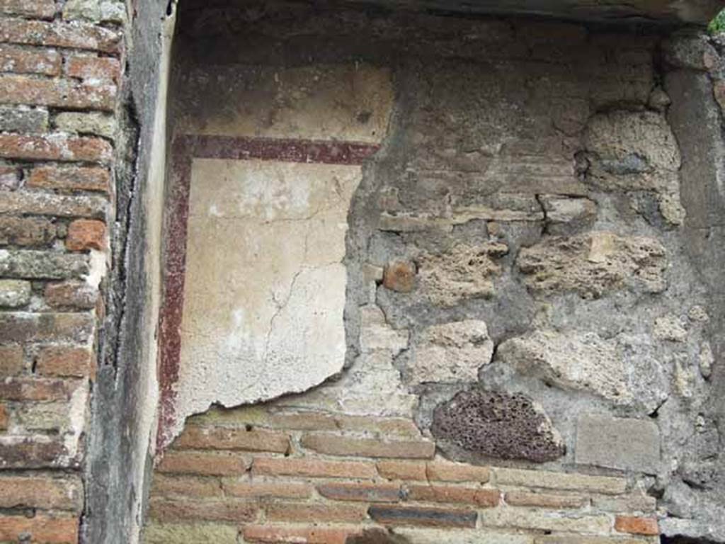 IX.9.8 Pompeii. May 2010. Upper east wall, remains of painted decoration in north-east corner.