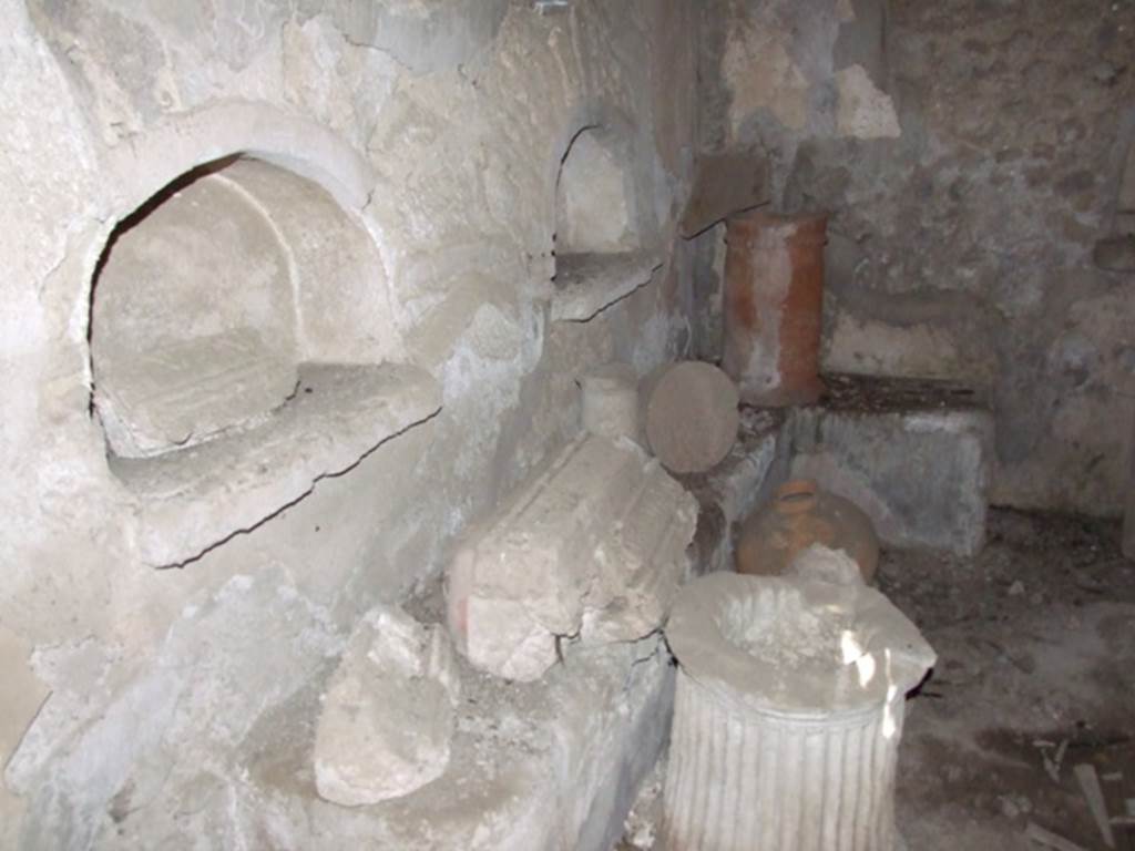 IX.9.10 Pompeii. March 2009. North wall, 2 arched niches, and below them, a masonry bench built along the north wall and part of the east wall.