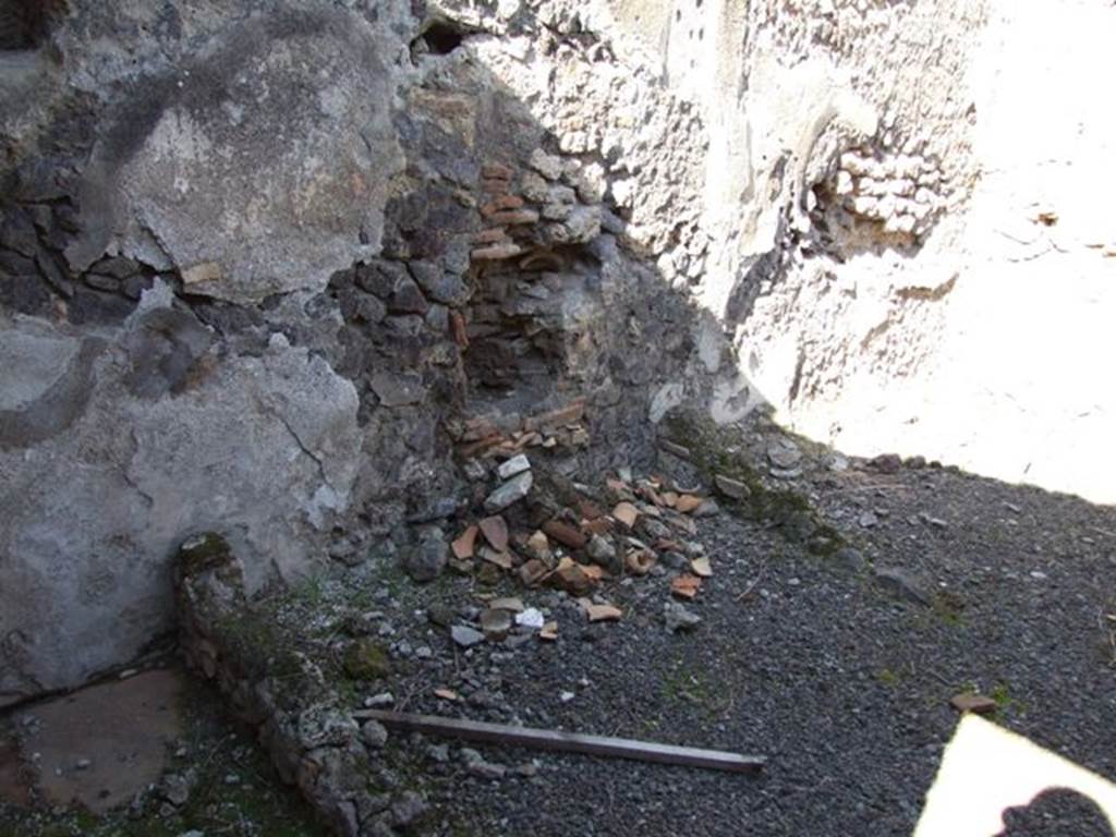 IX.9.12 Pompeii. March 2009. Room 15, north wall of kitchen. On the left of the photo would be the area for the small impluvium. In the centre would be the area where the latrine was found. On the right would have been the hearth area. When it was discovered, the floor of the hearth was destroyed.
See Notizie degli Scavi, 1891, (p.256)