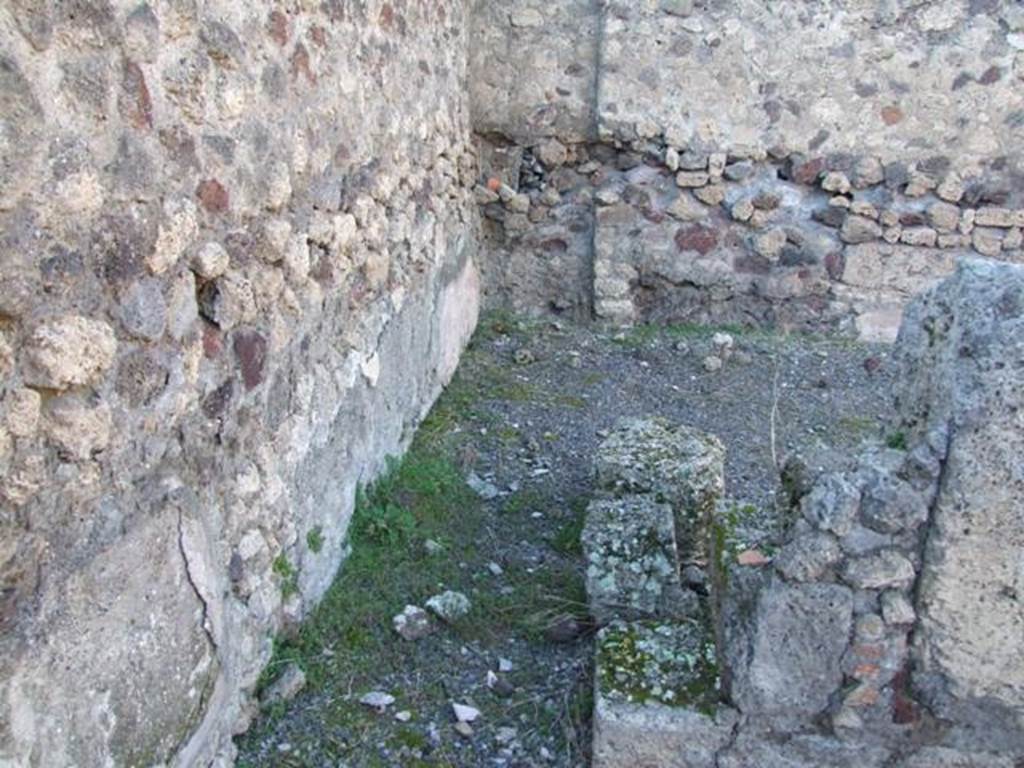 IX.9.a Pompeii. March 2009. Looking north into room “g”, on north-west side of the garden.
The room was described as opening from the north portico with two doorways of varying widths. The room was quite spacious and used maybe as a triclinium. It had flooring of crushed brick. The walls were painted yellow with stucco relief and green painted cornice, divided by narrow bands of white stucco on a red painted background and ornamented with leaves. Between the panels and the plinth (zoccolo) ran a band of stucco also in relief, imitating coloured marble. Later this decoration was altered, as could be seen on the plinth of the west wall. See Notizie degli Scavi, 1888, p.515