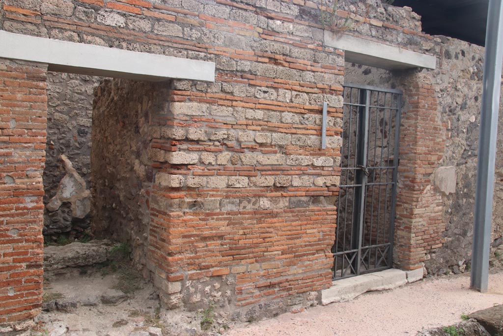 IX.9.b Pompeii, on left. October 2023. Steps to upper floor, with entrance doorway at IX.9.c, on right. Photo courtesy of Klaus Heese.