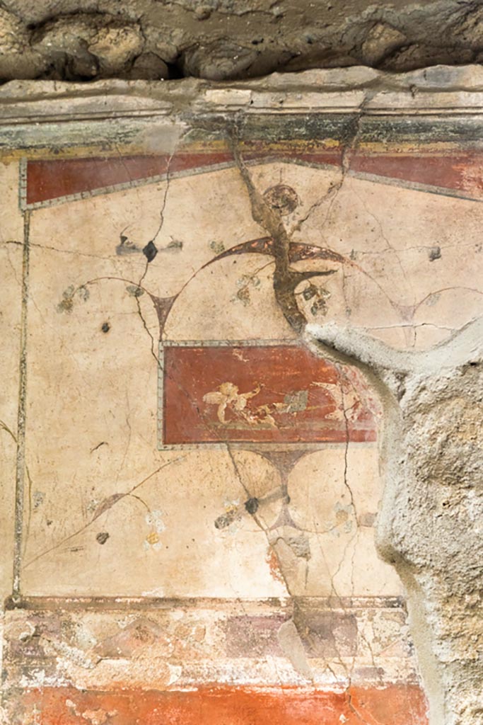 IX.9.c Pompeii. March 2023.
Detail of painted panel showing cupid fallen from chariot from upper centre of east wall.
Photo courtesy of Johannes Eber.