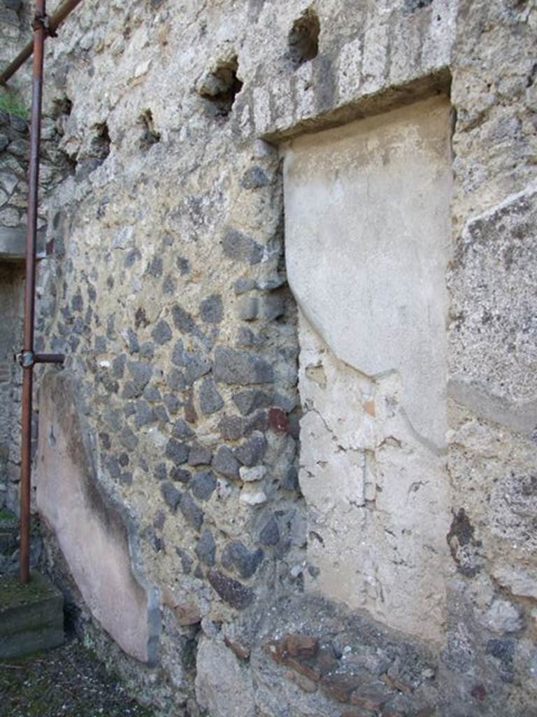 IX.9.c Pompeii. March 2009. South wall of south-east corner of portico area, showing recess and above, the holes for the beam supports for the mezzanine floor.