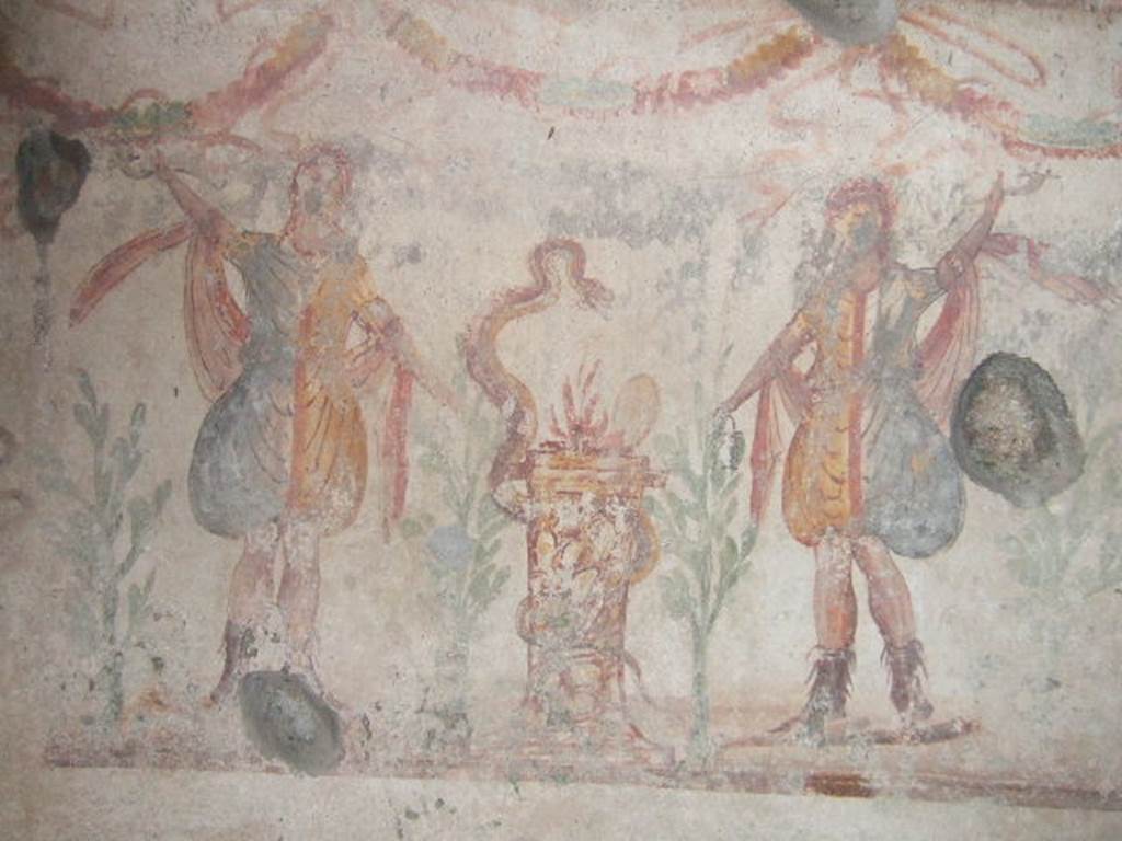 IX.9.c Pompeii. December 2005. Kitchen. Lararium painting.
Two Lares either side of a round altar which has a snake winding round it.