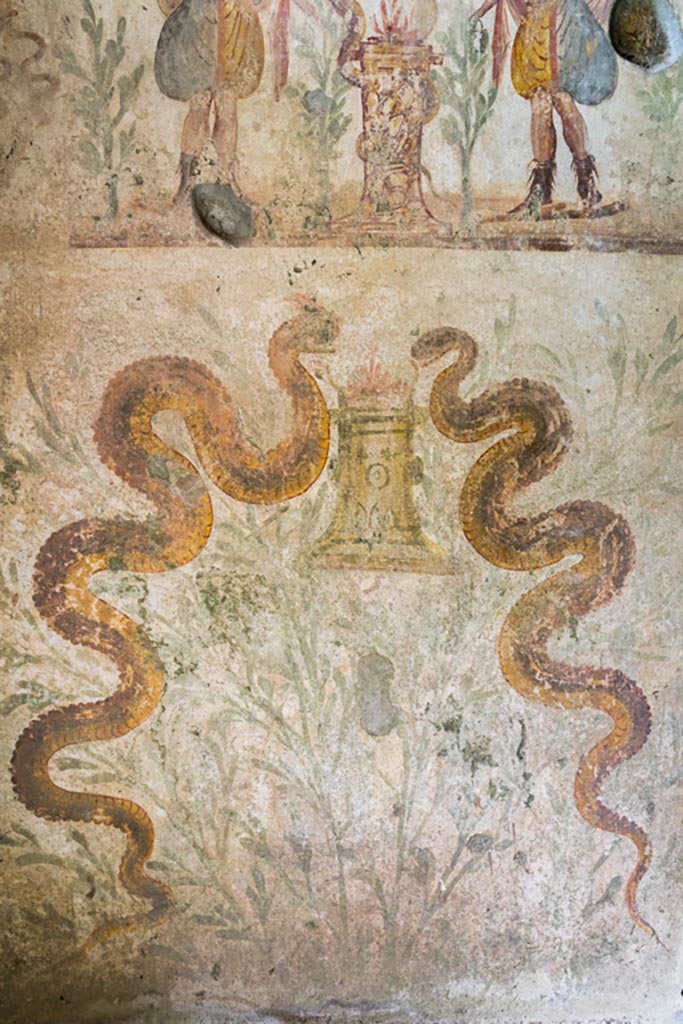 IX.9.c Pompeii. March 2023.
Two serpents painted on north wall of kitchen area. Photo courtesy of Johannes Eber.