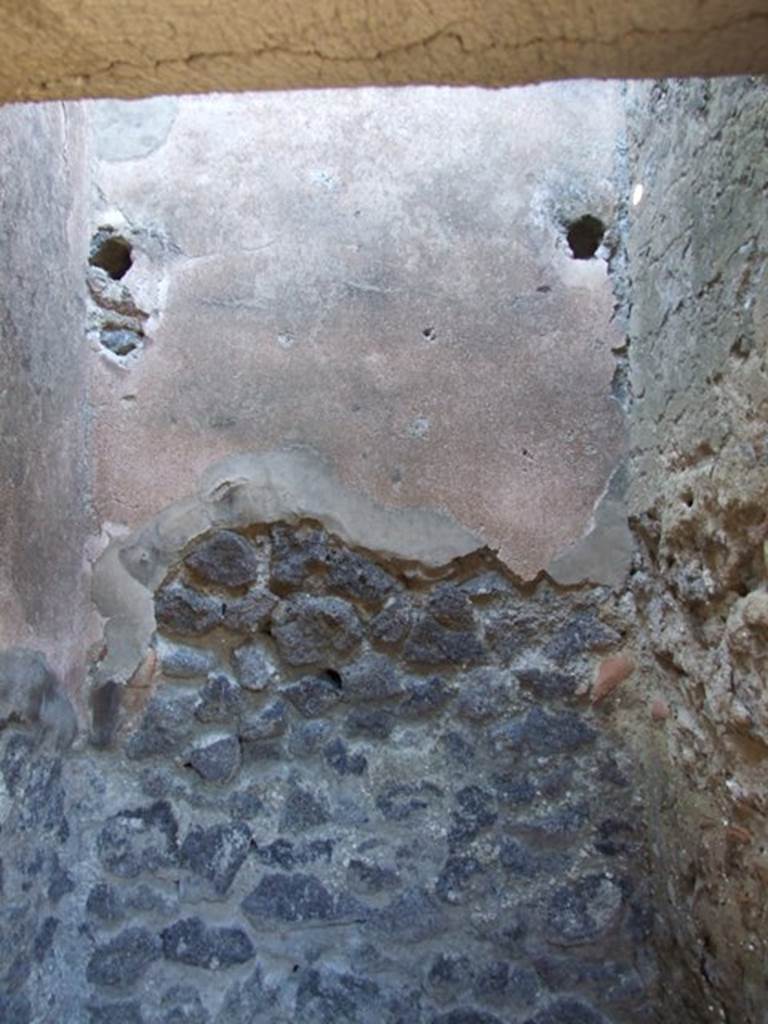 IX.9.d Pompeii. March 2009. Room d. Cupboard. North wall with holes for shelving supports.