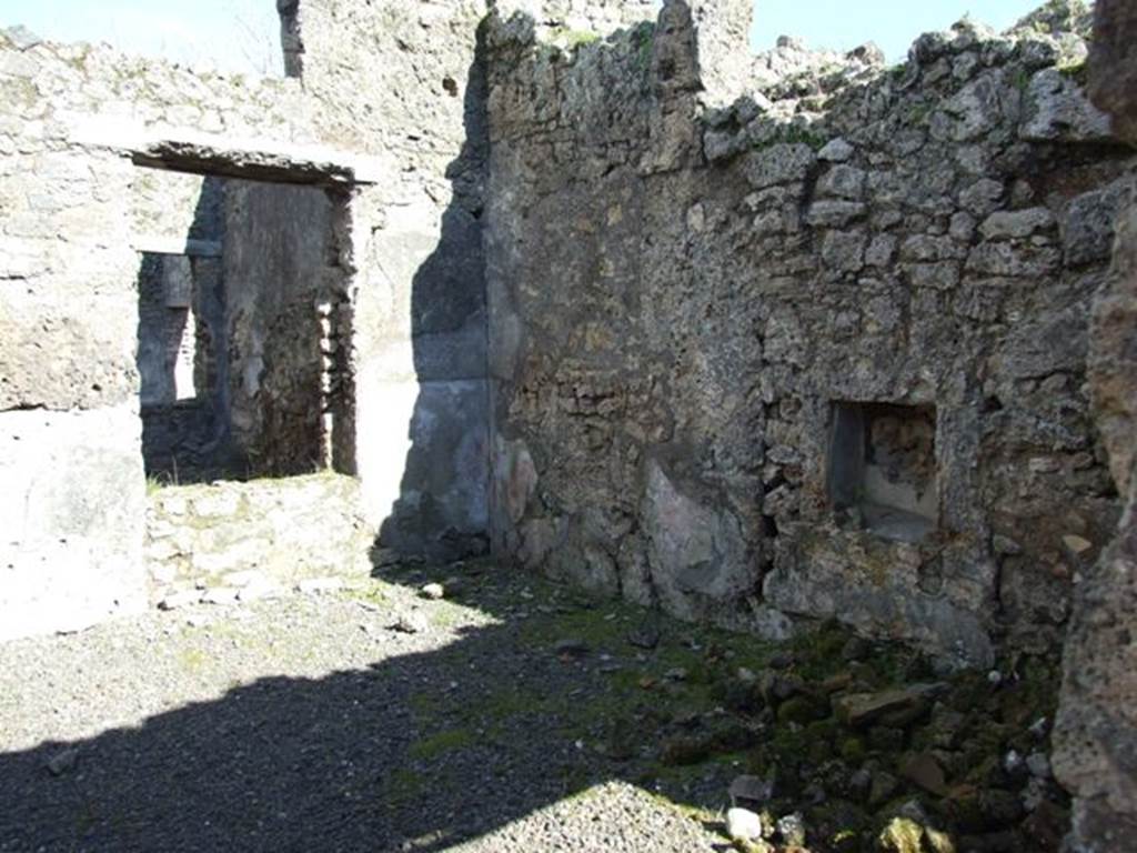 IX.9.e Pompeii. March 2009. Room 17, looking south-east across small atrium containing stairs to upper floor. According to NdS, this was a covered atrium also with a beaten floor, and walls of rustic white plaster with a high red zoccolo. The plaster was lacking on the north wall, against which was the masonry beginnings of a staircase. This staircase would have continued in wood and led to the rooms above the entrance corridor and two rooms leading from it (rooms 18 and 19). It would also have led to the balcony which stuck out into the roadway above the entrance doorway. This had now fallen, leaving no other trace than the holes in the outer wall for holding the frame.
See Notizie degli Scavi, 1891, p.255.