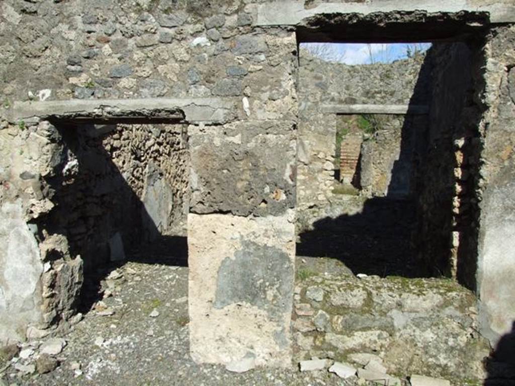 IX.9.e Pompeii. March 2009. Room 17, east wall of atrium, with doorway and window to room 16, the light-yard.