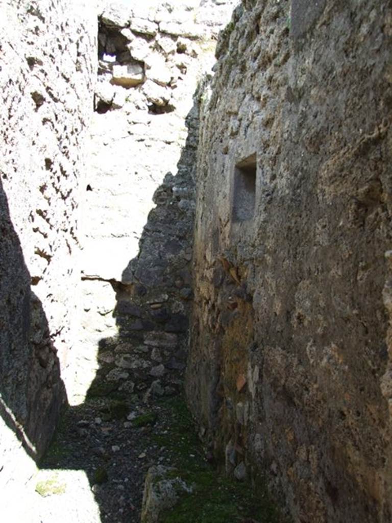IX.9.f Pompeii. March 2009. Looking east along south wall of small room, with site of staircase and latrine.