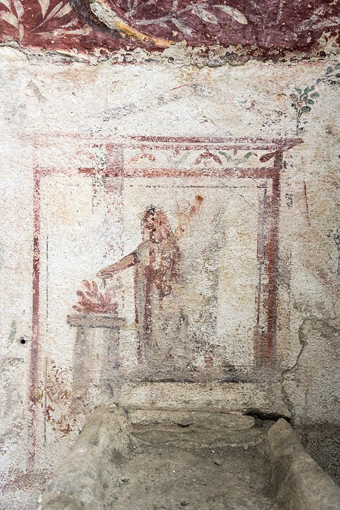 IX.10.1, Pompeii. July 2024. 
Lararium and altar found in room 12. Photo courtesy of Johannes Eber.
The altar is surmounted by a painted rectangular aedicule terminating in vegetal whorls, and which frames the Genius patris familias with cornucopia and patera making libations at a circular altar.
L’altare è sormontato da un’edicola rettangolare dipinta e terminante in girali vegetali, che inquadra il Genius patrisfamilias con cornucopia e patera che compie libagioni presso un altare circolare.
See PAP e-journal 6, 28.09.2023, p. 65, fig. 14. Download: PAP e-journals 2023 collection volumes 01-09

