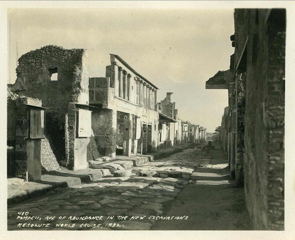 IX.11.8 Pompeii. 1932, looking east on Via dell’ Abbondanza.
The doorway to IX.11.8 can be seen on the left, between two “protected” graffiti, and with a high, end wall with window.
Photo taken during a shore-visit from the ship Resolute’s world cruise in 1932. Photo courtesy of Rick Bauer.