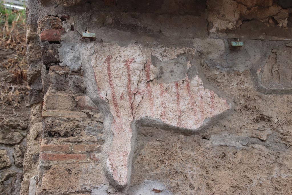 IX.11.8 Pompeii. May 2024.
Detail of remaining graffiti on front wall, east of doorway, at east end of insula. Photo courtesy of Klaus Heese.