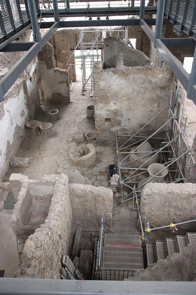IX.12.6 Pompeii. October 2024.
Looking south across the bakery room “e” and “f”, from room “g”. Photo courtesy of Klaus Heese.