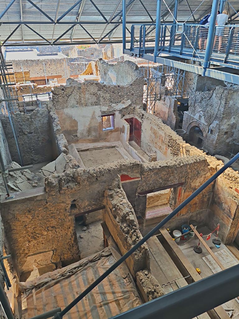 IX.12.6 Pompeii, June 2024.
Looking south from above rooms “n” and “m”, towards rooms “o”, “n1” and “f”, bakery room with oven “d”.
Photo courtesy of Giuseppe Ciaramella.