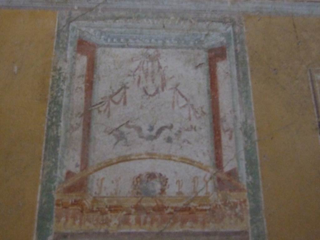IX.12.9 Pompeii. March 2009. Room 12, west wall above central painting. Painting with architectural theme (and mask?).